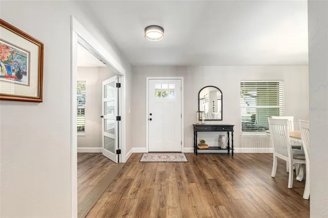 a living room with furniture and a table with wooden floor