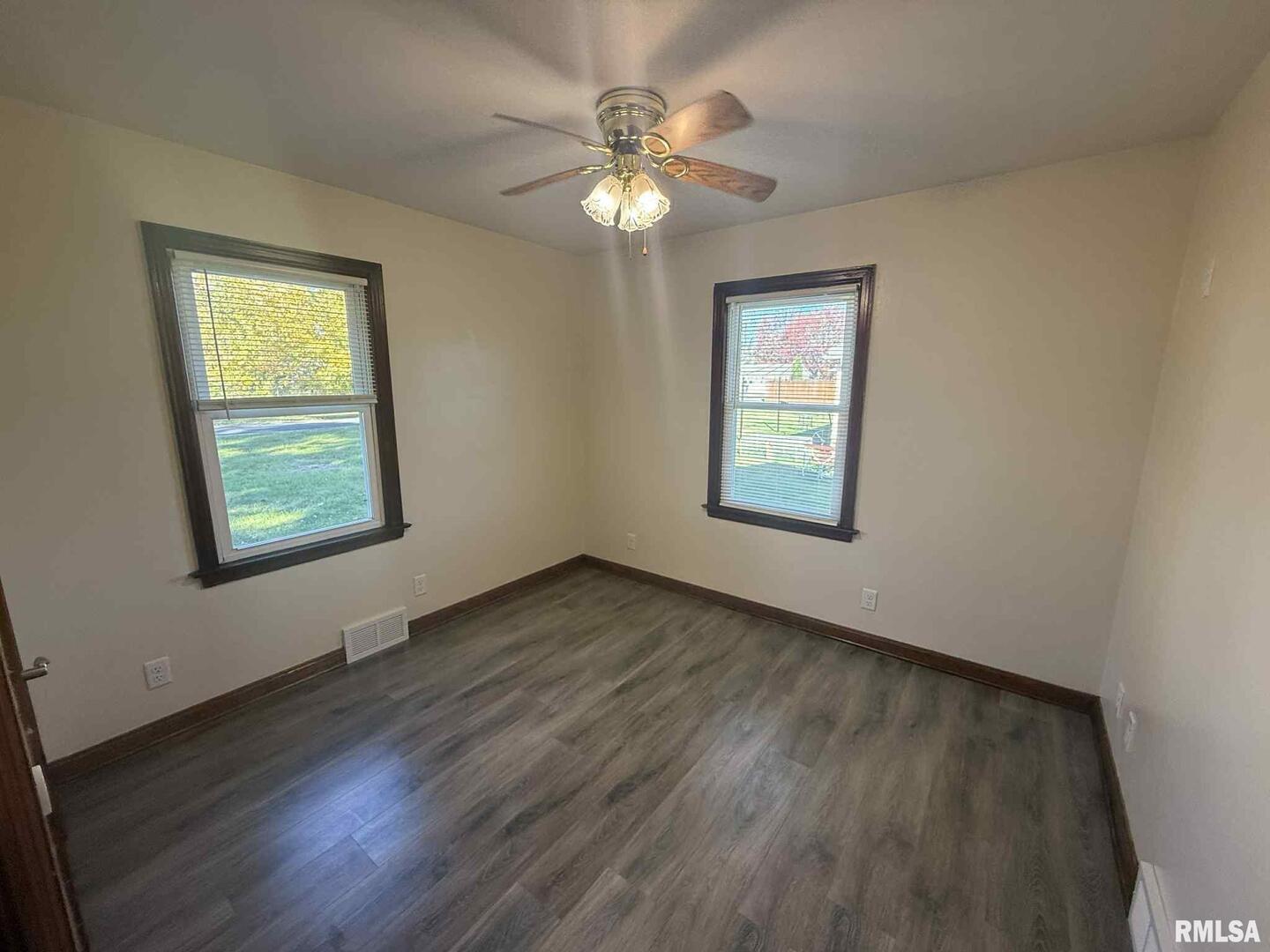 3 Anderson Avenue Milan, IL 61264 - Photo 22 of 30 a view of an empty room with wooden floor and a window