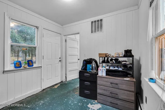a view of a dresser and window in a room