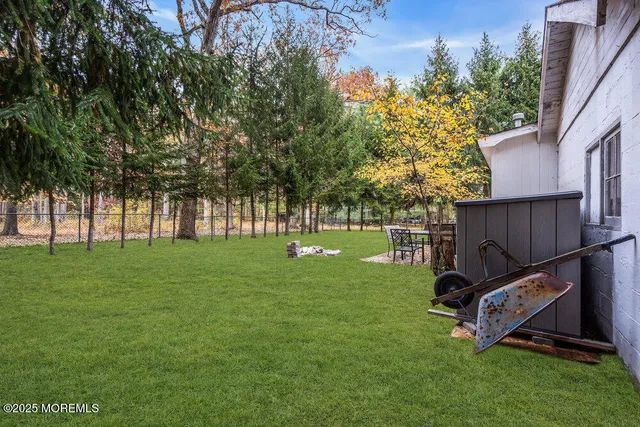 a view of a backyard with large trees