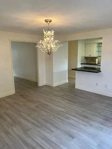 a view of a kitchen with a sink and dishwasher wooden floor