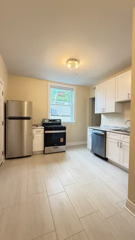 a kitchen with stainless steel appliances a refrigerator sink and cabinets
