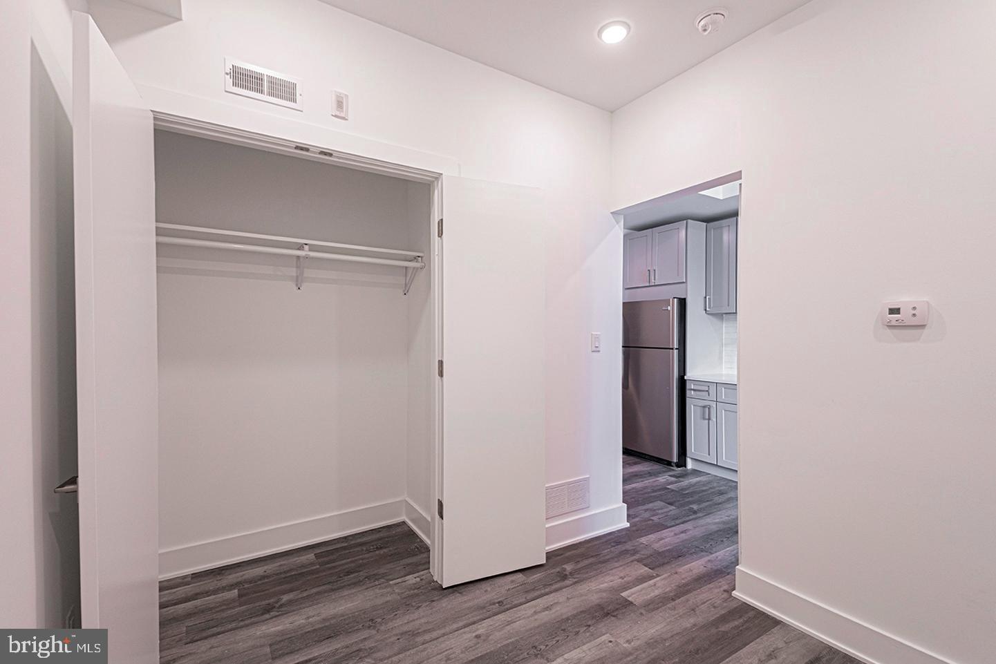 1245 Ridge Avenue, Unit 103 Philadelphia, PA 19123 - Photo 10 of 18 a view of an empty room with wooden floor & closet