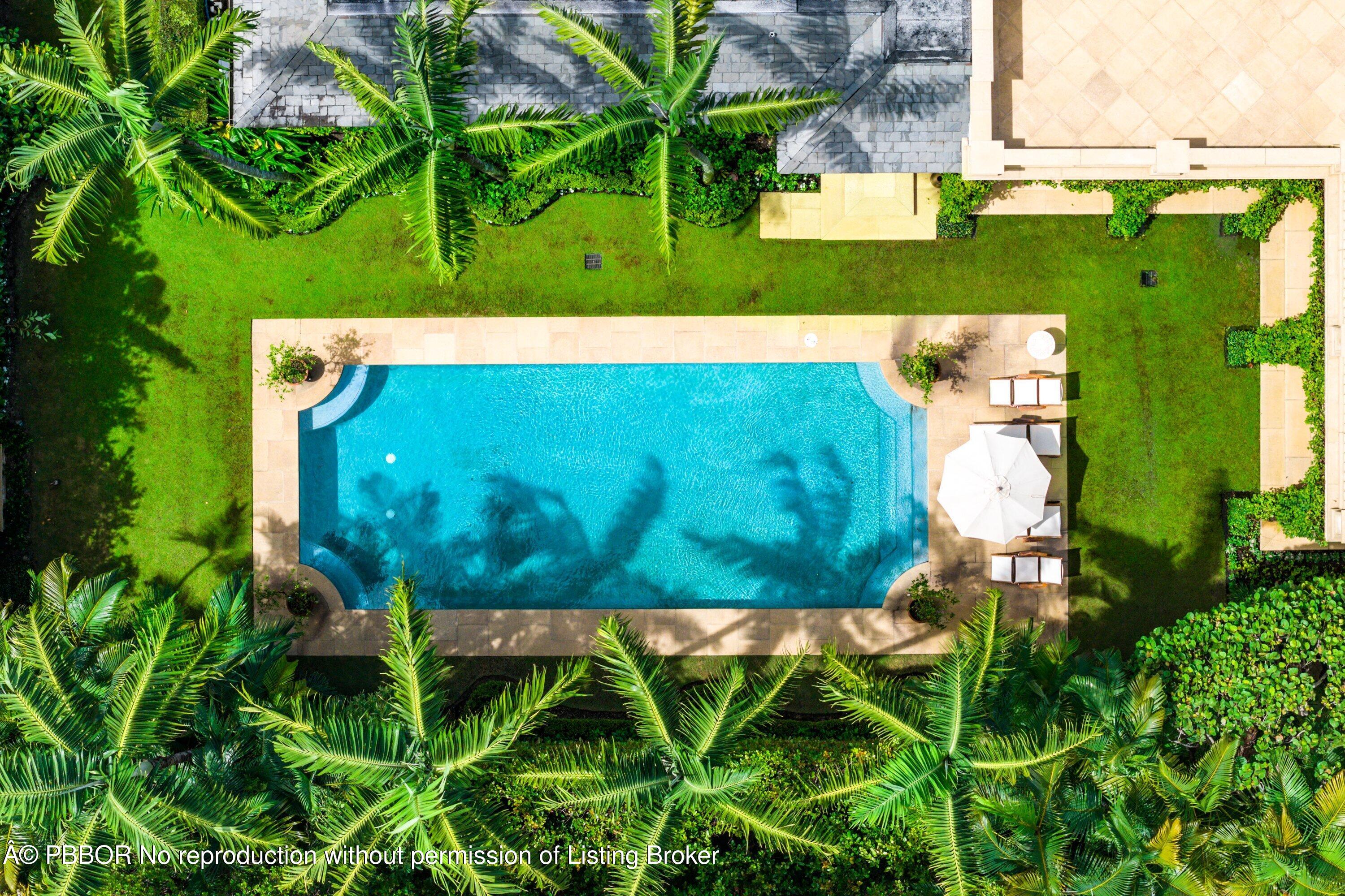 242 Wells Road Palm Beach, FL 33480 - Photo 43 of 54 a view of a swimming pool with a yard