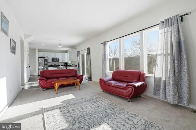 a living room with furniture and large windows