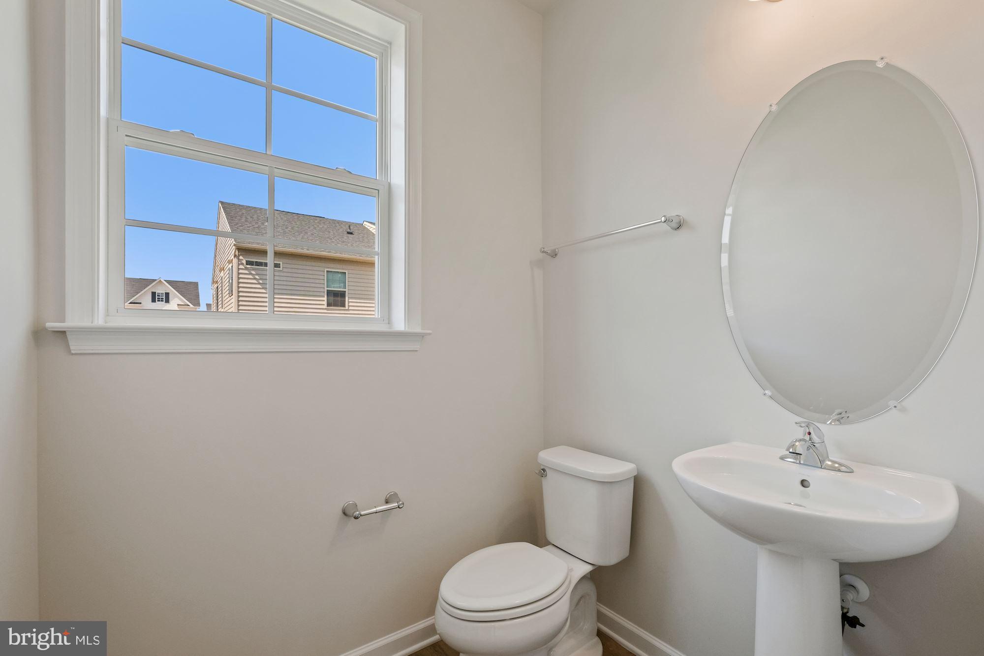 6211 Davinci Street Frederick, MD 21703 - Photo 11 of 30 a bathroom with a sink mirror and toilet