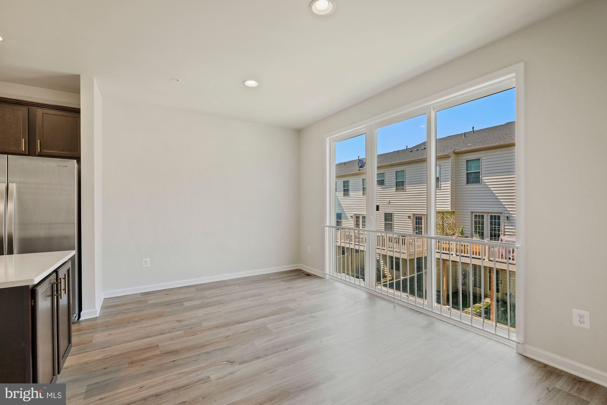 6211 Davinci Street Frederick, MD 21703 - Photo 12 of 30 a view of empty room with wooden floor and fan
