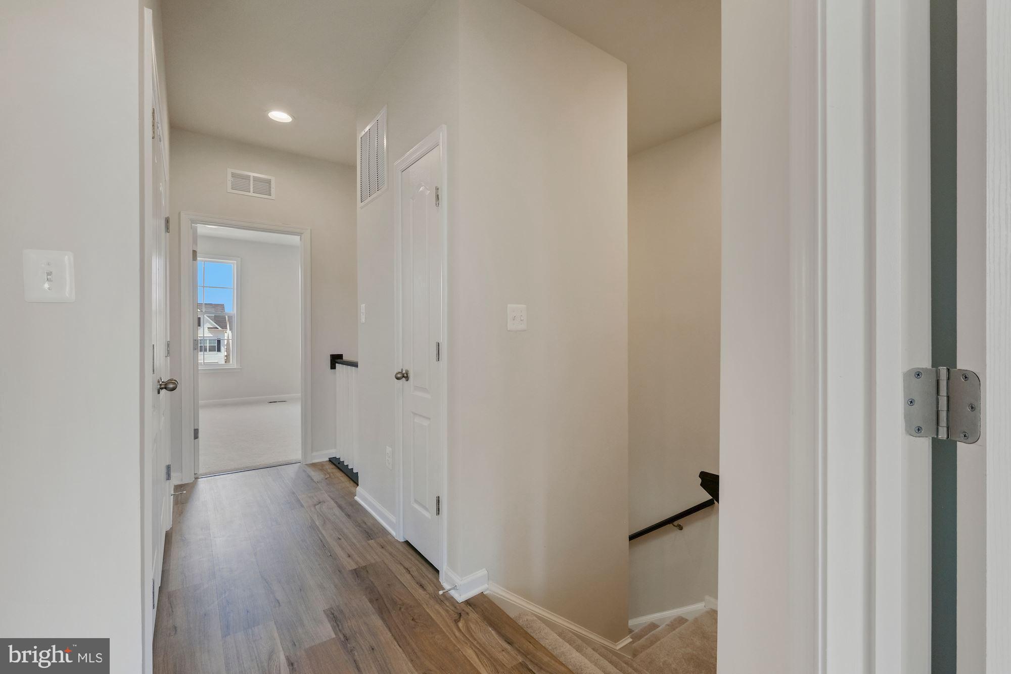 6211 Davinci Street Frederick, MD 21703 - Photo 15 of 30 a view of a hallway with wooden floor