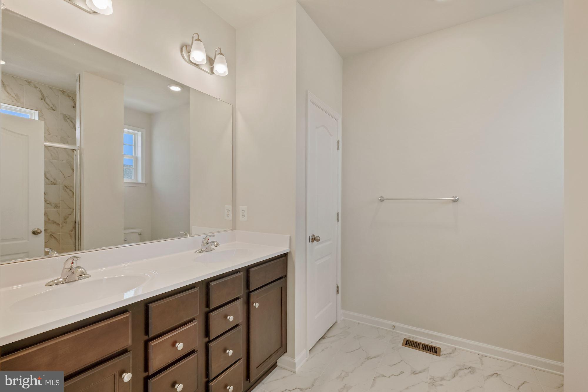 6211 Davinci Street Frederick, MD 21703 - Photo 20 of 30 a bathroom with a sink and a mirror