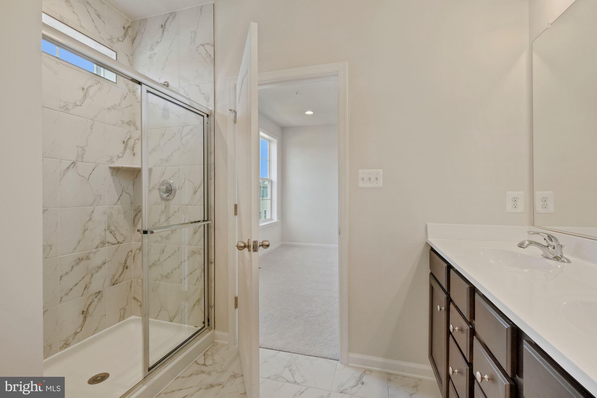 6211 Davinci Street Frederick, MD 21703 - Photo 21 of 30 a bathroom with a shower and sink