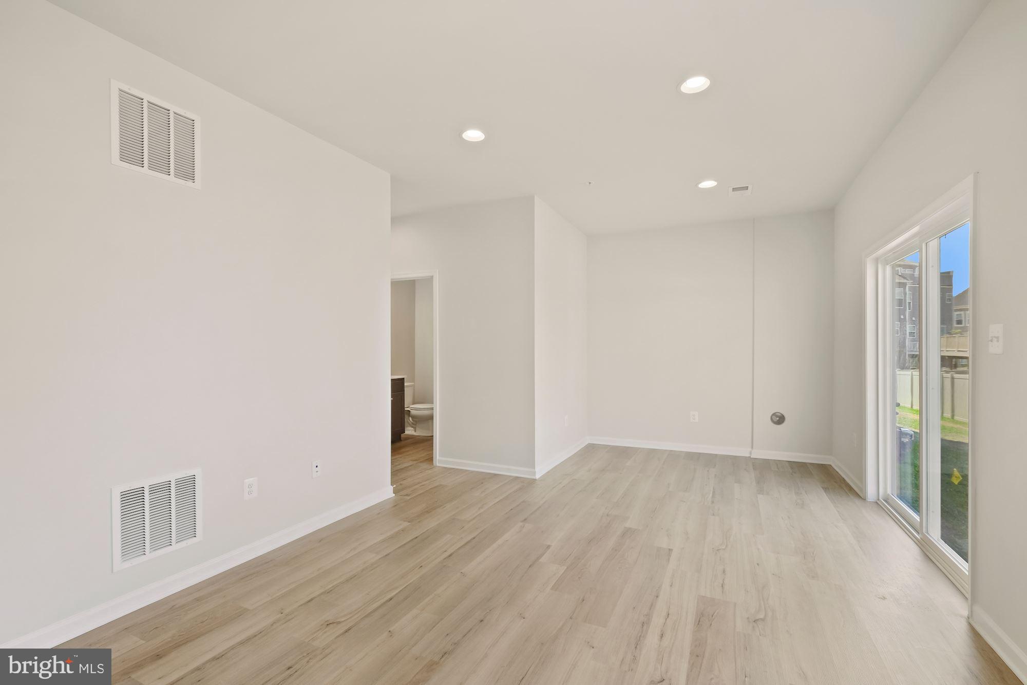 6211 Davinci Street Frederick, MD 21703 - Photo 27 of 30 a view of an empty room with wooden floor