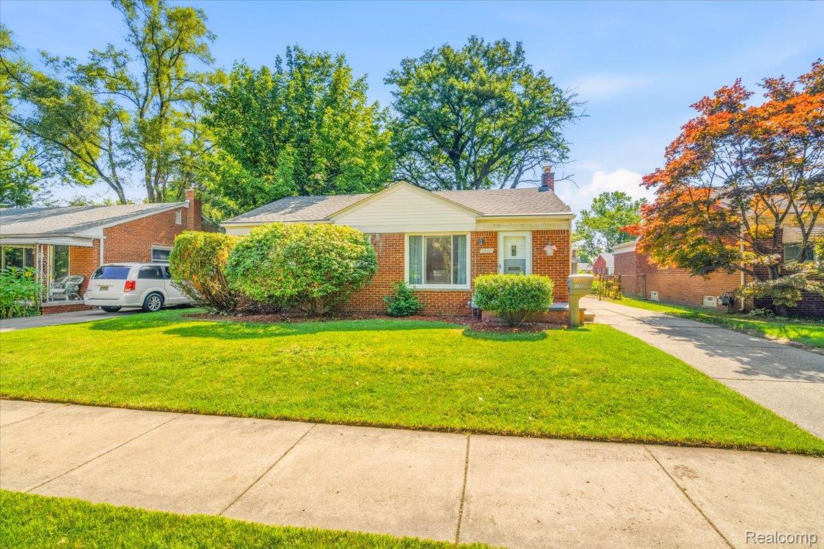 11802 Columbia Street Redford, MI 48239 - Photo 27 of 39 Brick ranch-style residence featuring a prominent front lawn, established landscaping, a concrete driveway, and mature trees