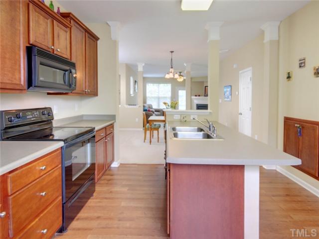 8434 Central Drive Raleigh, NC 27613 - Photo 6 of 25 a kitchen with stainless steel appliances granite countertop a sink a stove top oven a counter space and cabinets