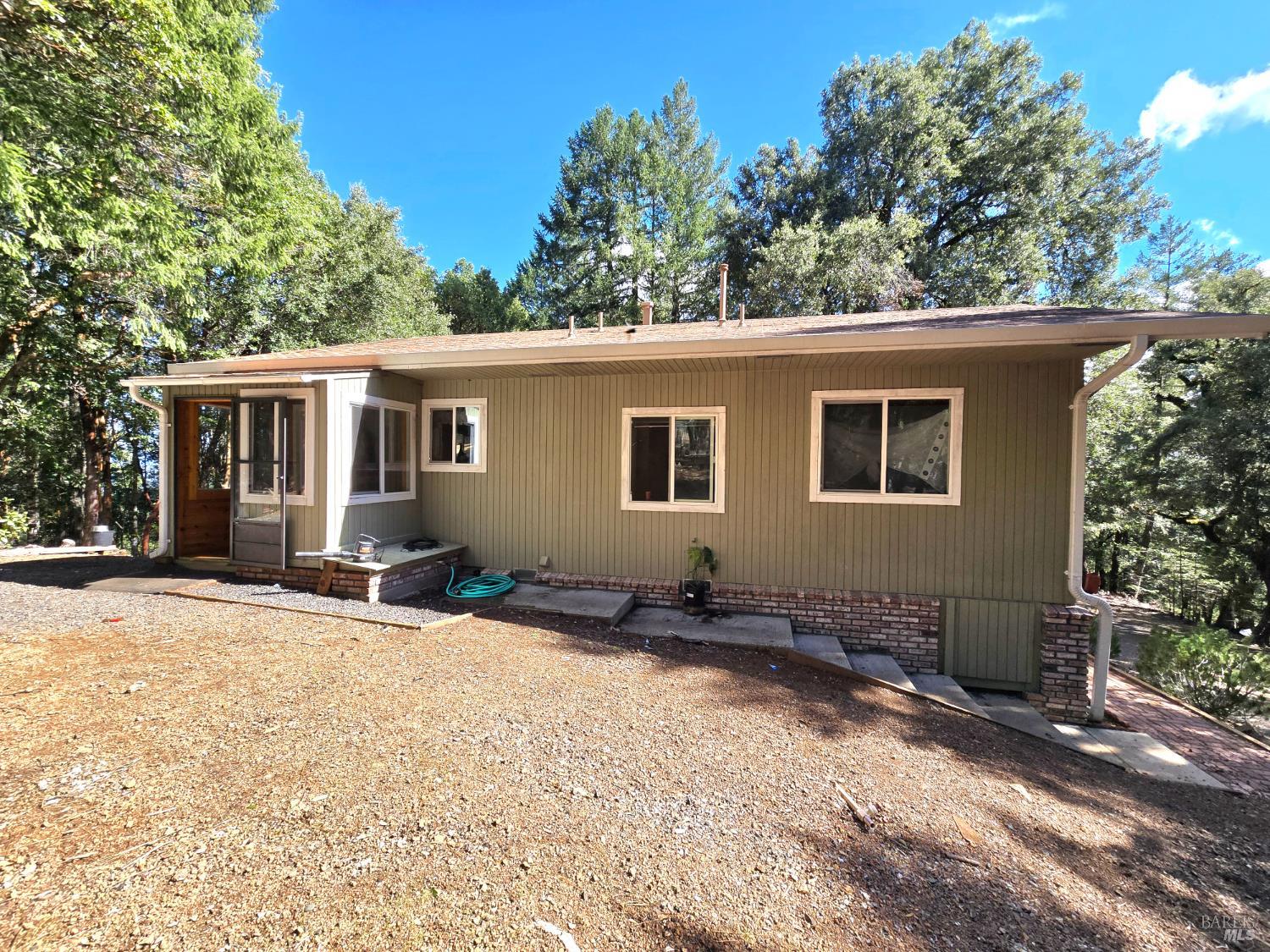 36193 Covelo Road Willits, CA 95490 - Photo 4 of 30 a backyard of a house with yard and outdoor seating