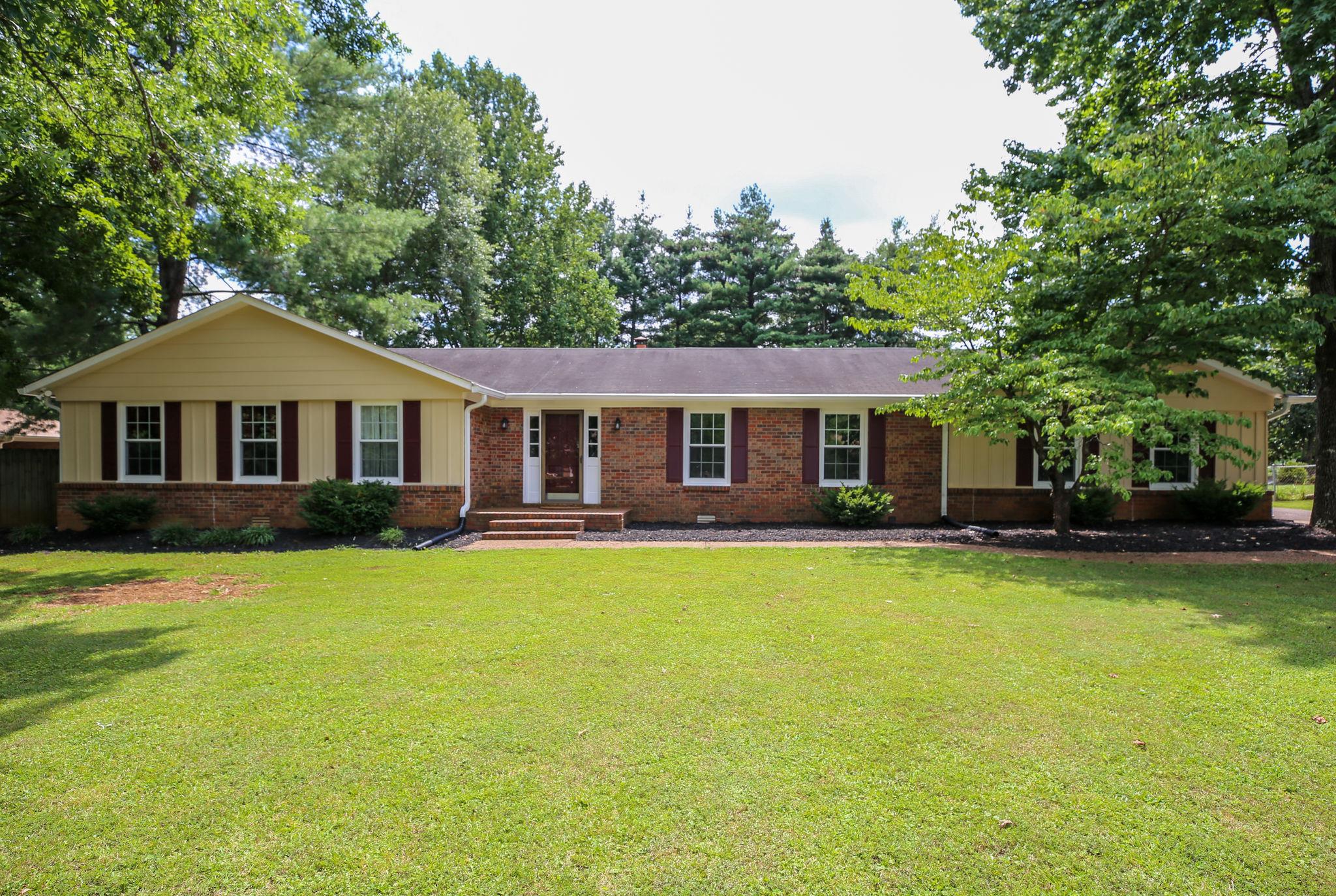 a front view of a house with swimming pool having outdoor seating