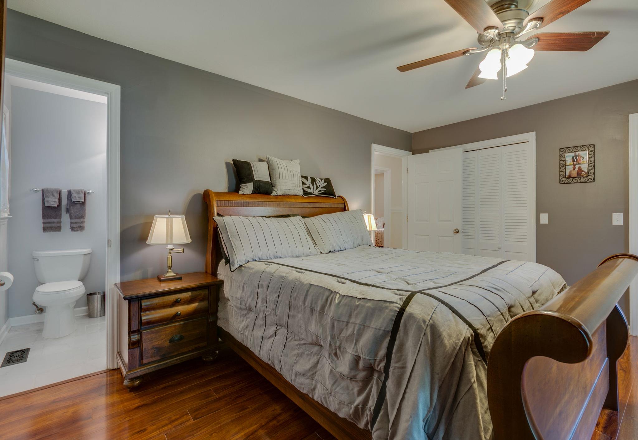 1649 Deerrun Road Murfreesboro, TN 37129 - Photo 11 of 28 a bedroom with a bed and a chandelier