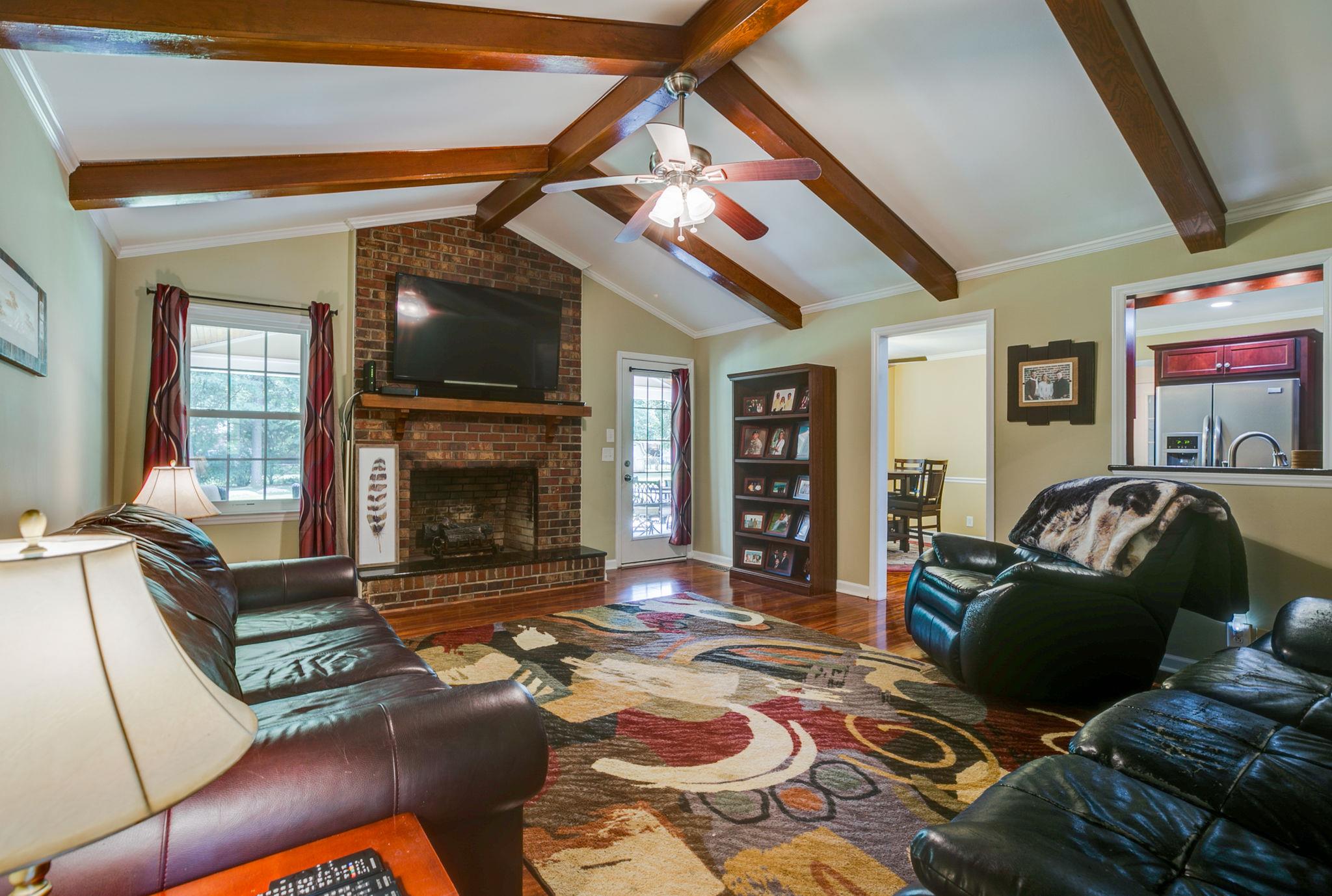 1649 Deerrun Road Murfreesboro, TN 37129 - Photo 17 of 28 a living room with furniture a flat screen tv and a fireplace