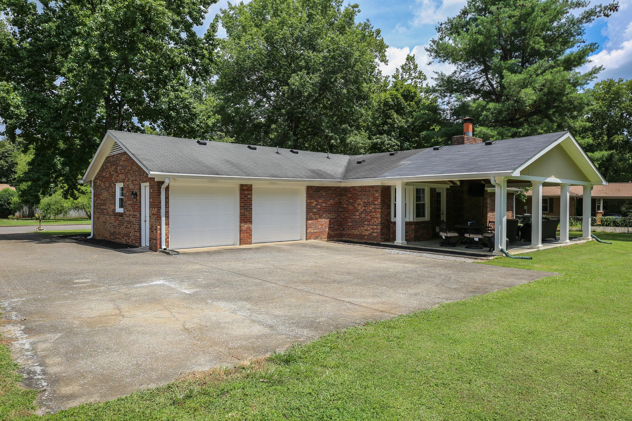 1649 Deerrun Road Murfreesboro, TN 37129 - Photo 25 of 28 a front view of a house with a garden and porch