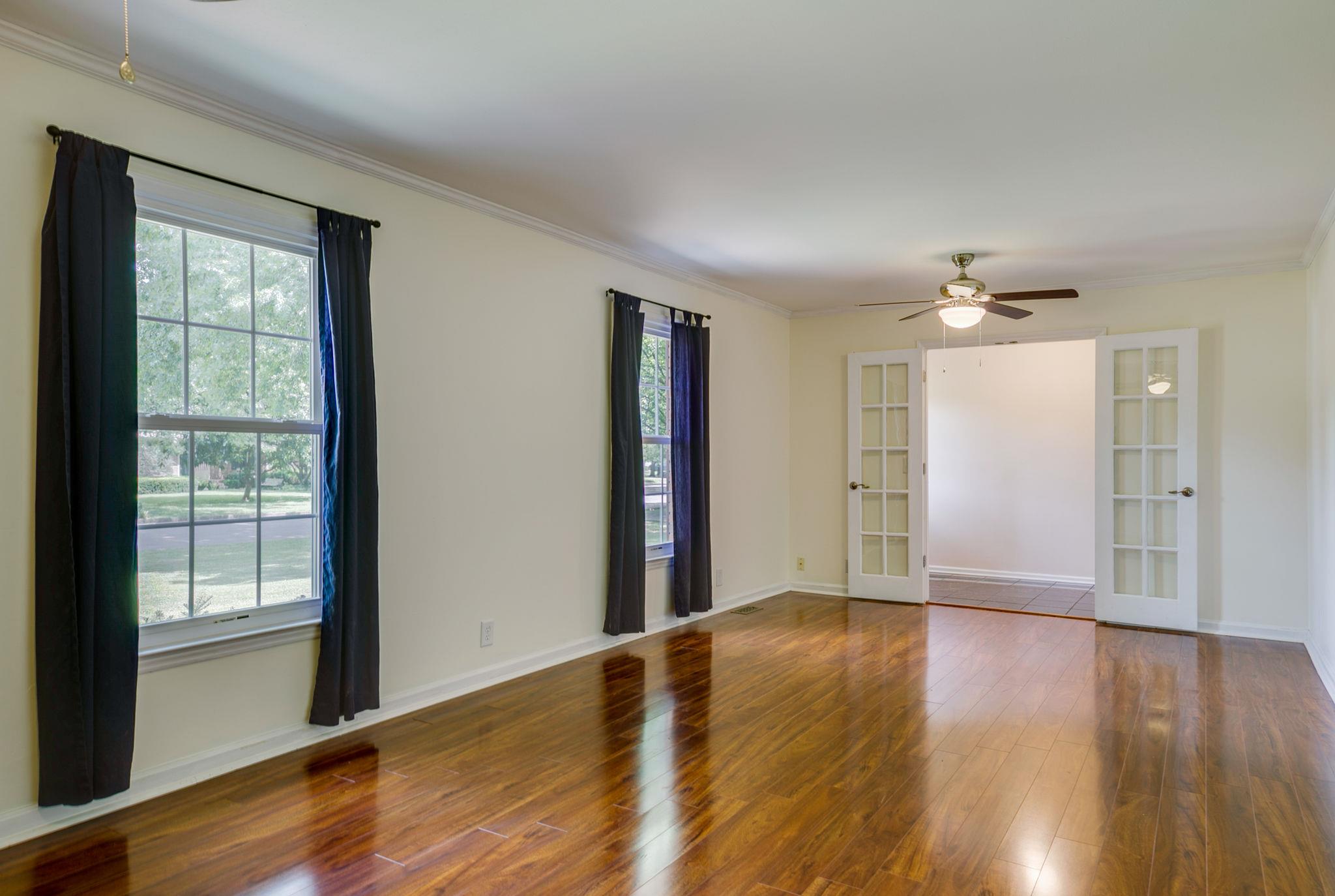 1649 Deerrun Road Murfreesboro, TN 37129 - Photo 7 of 28 a view of an empty room with wooden floor and a window