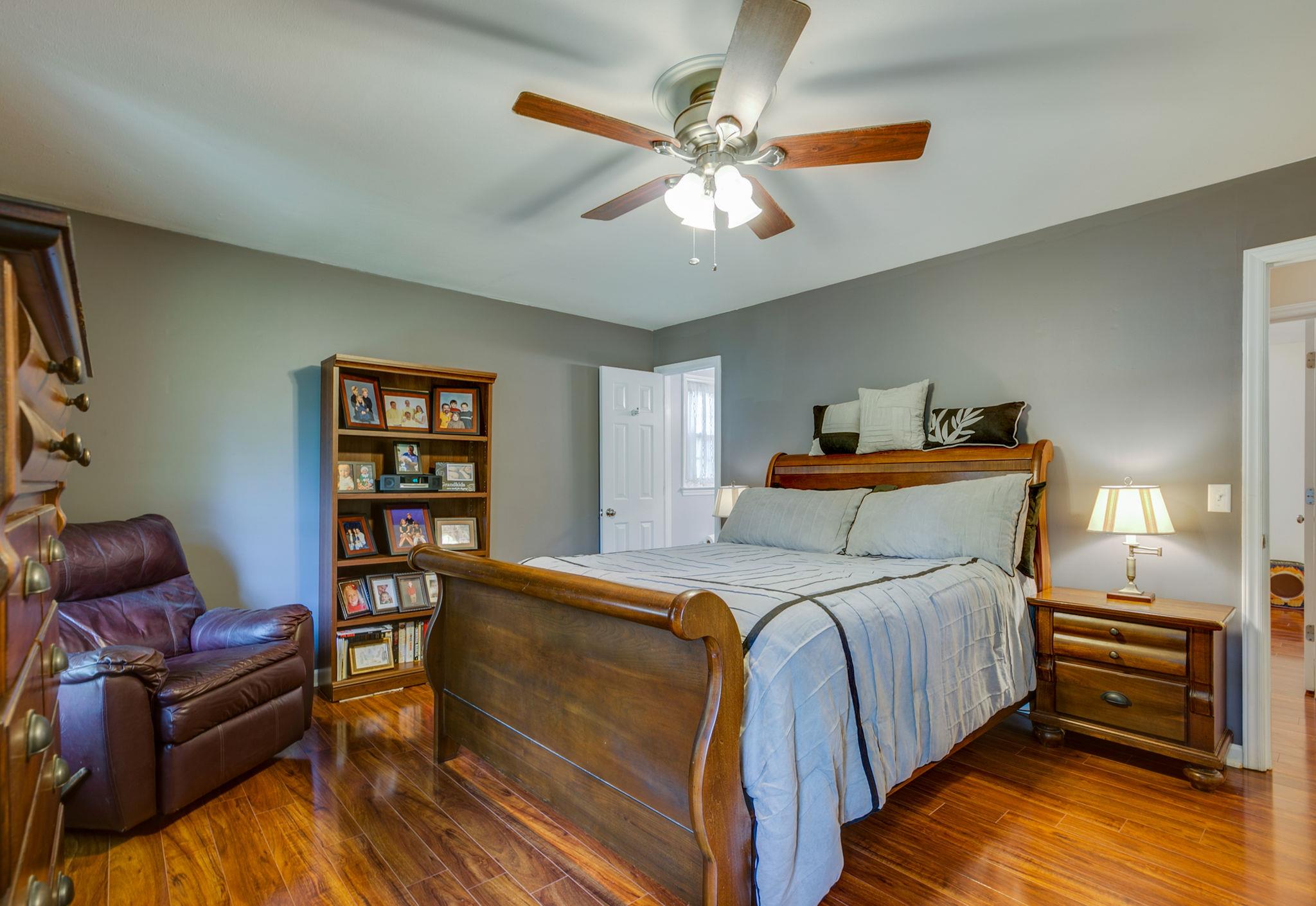 1649 Deerrun Road Murfreesboro, TN 37129 - Photo 10 of 28 a bedroom with a bed and a chandelier