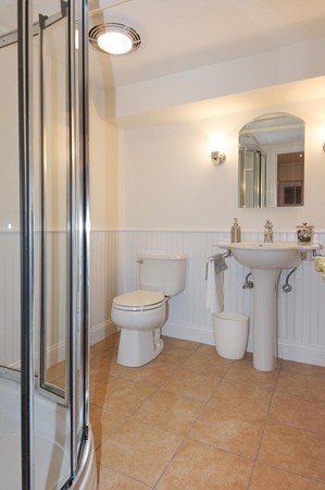 19 Highland Road Belmont, MA 02478 - Photo 25 of 30 a bathroom with a toilet sink and mirror