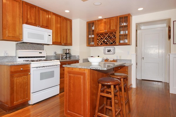 19 Highland Road Belmont, MA 02478 - Photo 6 of 30 a kitchen with stainless steel appliances a stove a refrigerator and a cabinets