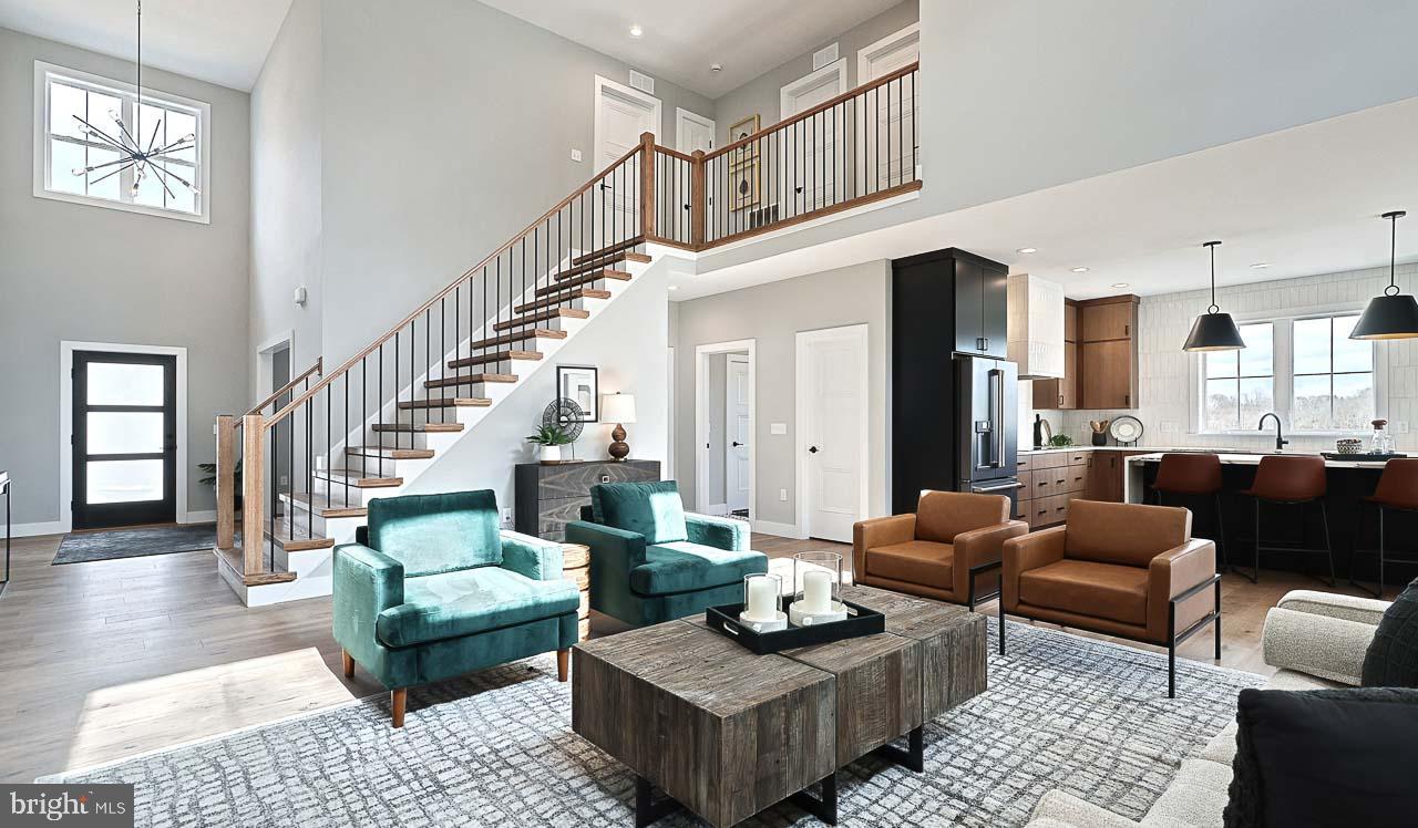 90 Tupelo Street Lititz, PA 17543 - Photo 11 of 38 a living room with furniture and a dining table with wooden floor
