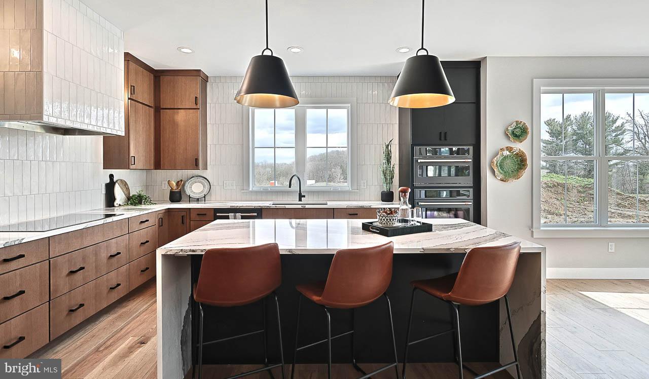 90 Tupelo Street Lititz, PA 17543 - Photo 14 of 38 a kitchen with stainless steel appliances granite countertop a sink a stove and a refrigerator