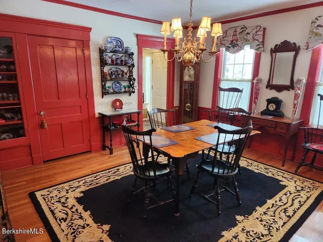 a living room with furniture a flat screen tv and floor to ceiling window