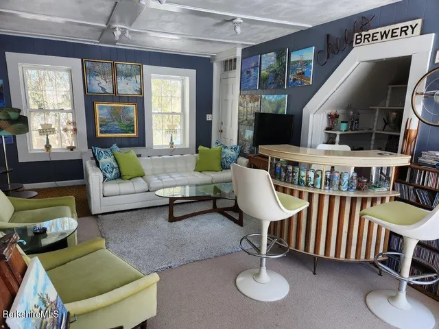 a bed sitting in a bedroom and a balcony