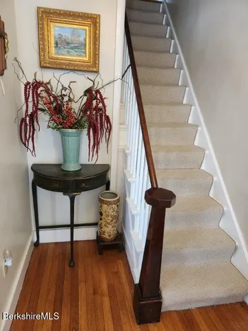 a bed room with a bed mirror and a dresser