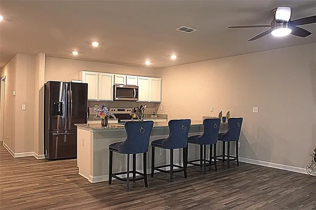 a view of a dining room with furniture a chandelier and wooden floor