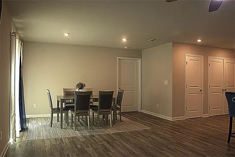 a view of a dining room with furniture and wooden floor