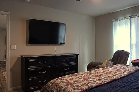 a bedroom with a bed and television