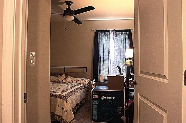 a bedroom with a bed and a window