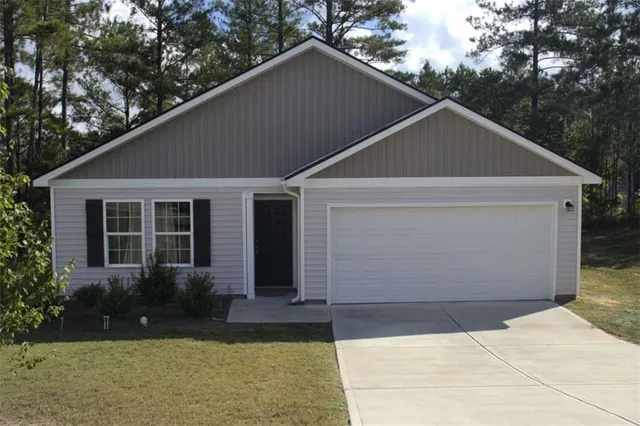 a front view of house with yard and green space