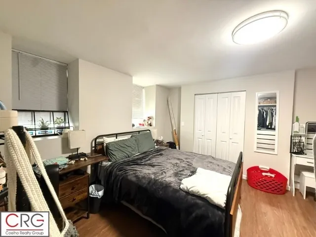 a bedroom with a bed and a couch