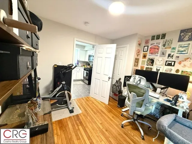 a view of a livingroom with workspace and a couch