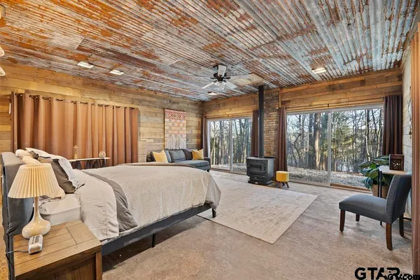 a spacious bedroom with a bed and a large window
