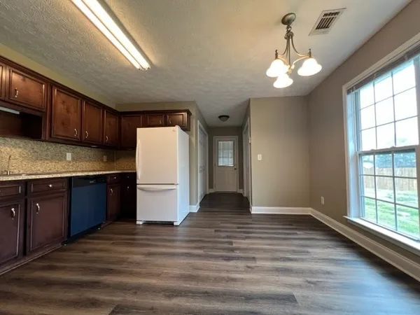 a kitchen with a refrigerator and cabinets