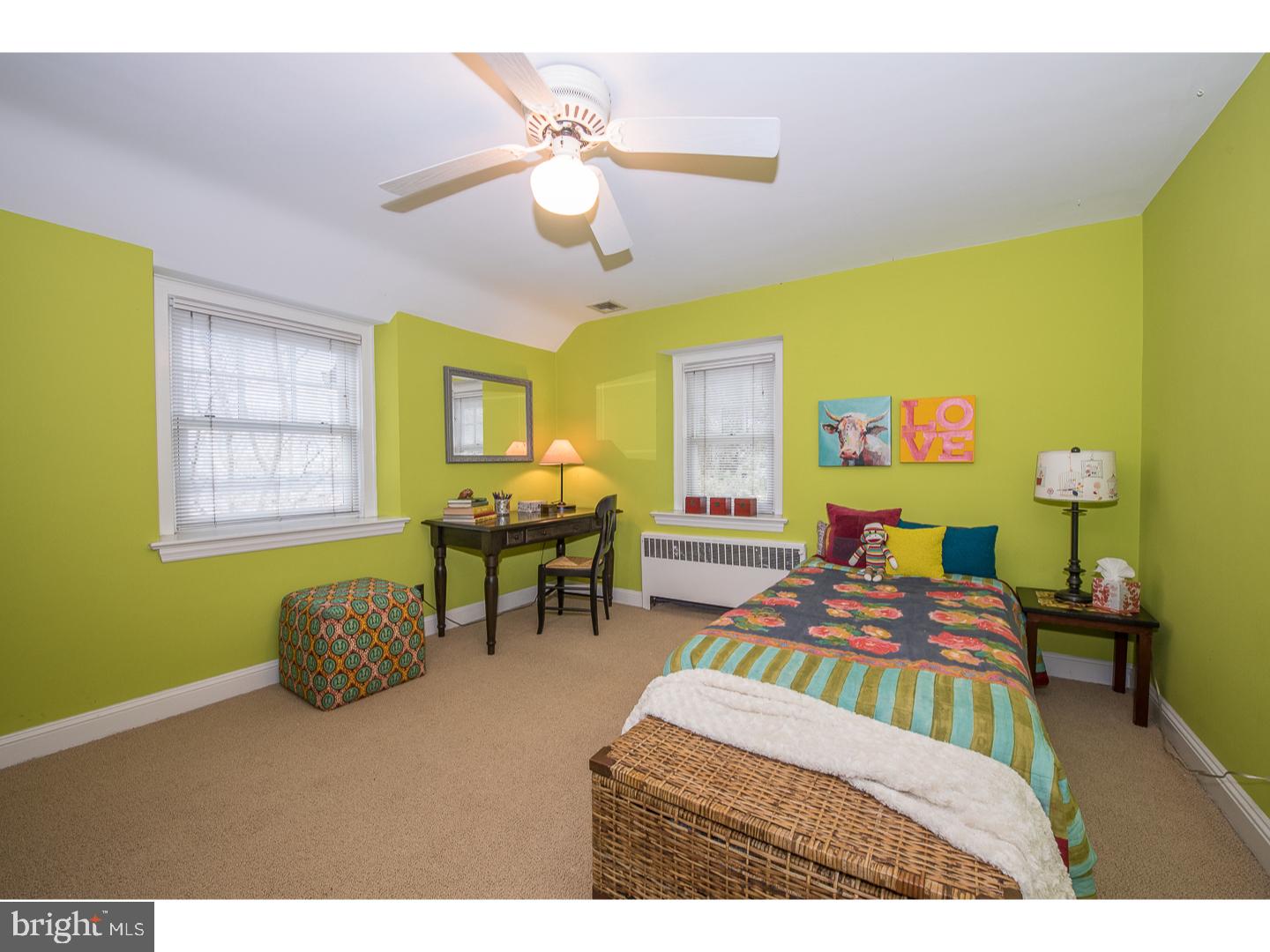 545 Manor Road Wynnewood, PA 19096 - Photo 19 of 25 a bedroom with a bed and a chandelier