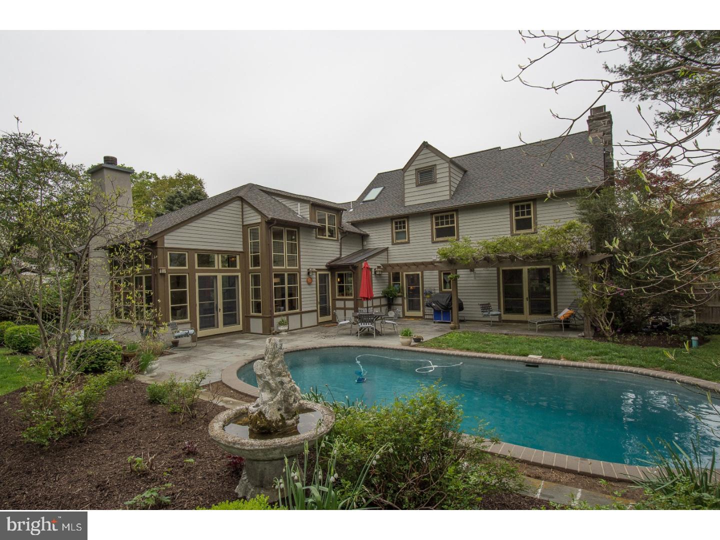545 Manor Road Wynnewood, PA 19096 - Photo 24 of 25 a front view of a house with a garden and swimming pool
