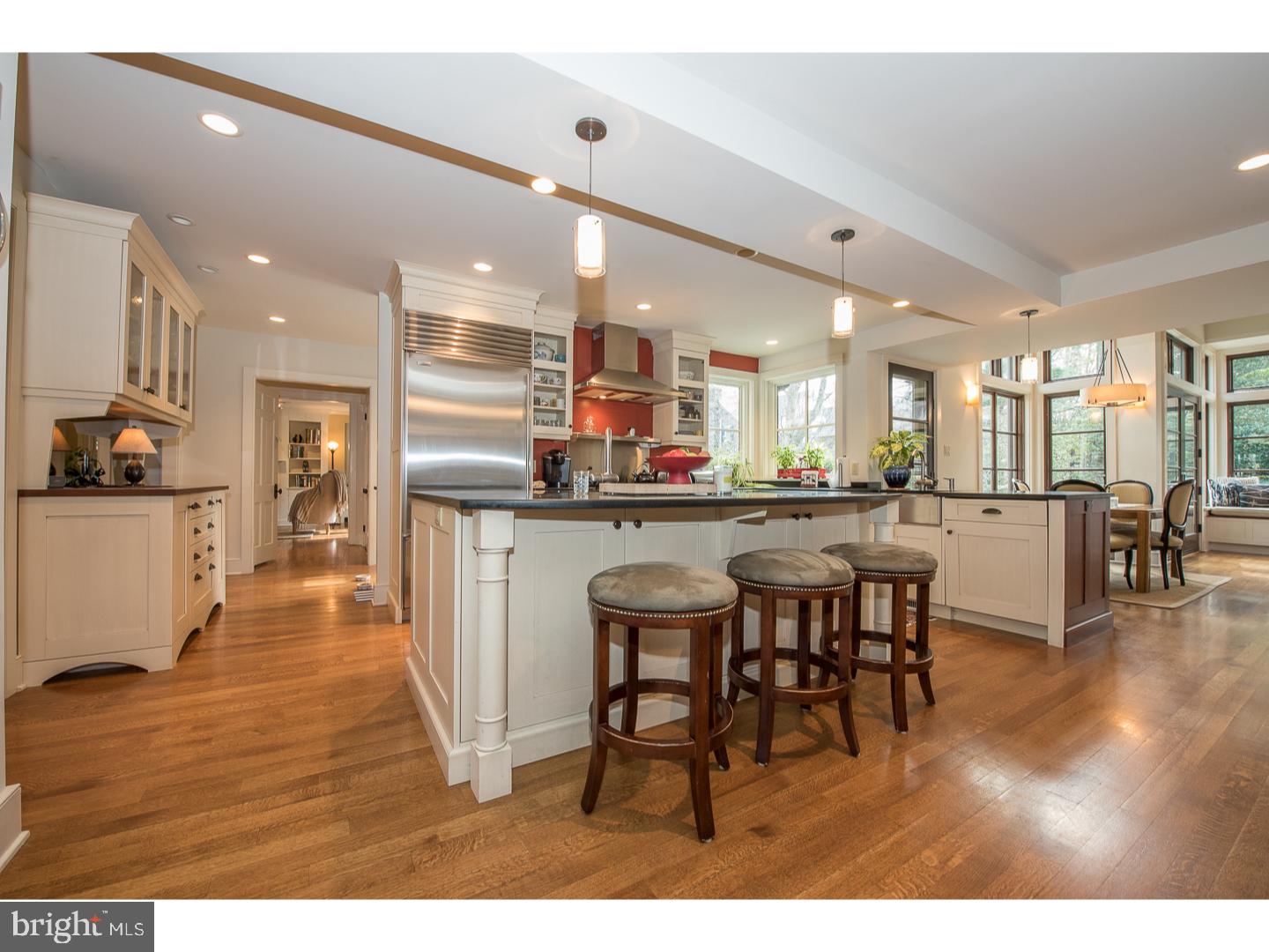 545 Manor Road Wynnewood, PA 19096 - Photo 9 of 25 a kitchen with stainless steel appliances kitchen island granite countertop a table chairs and a refrigerator
