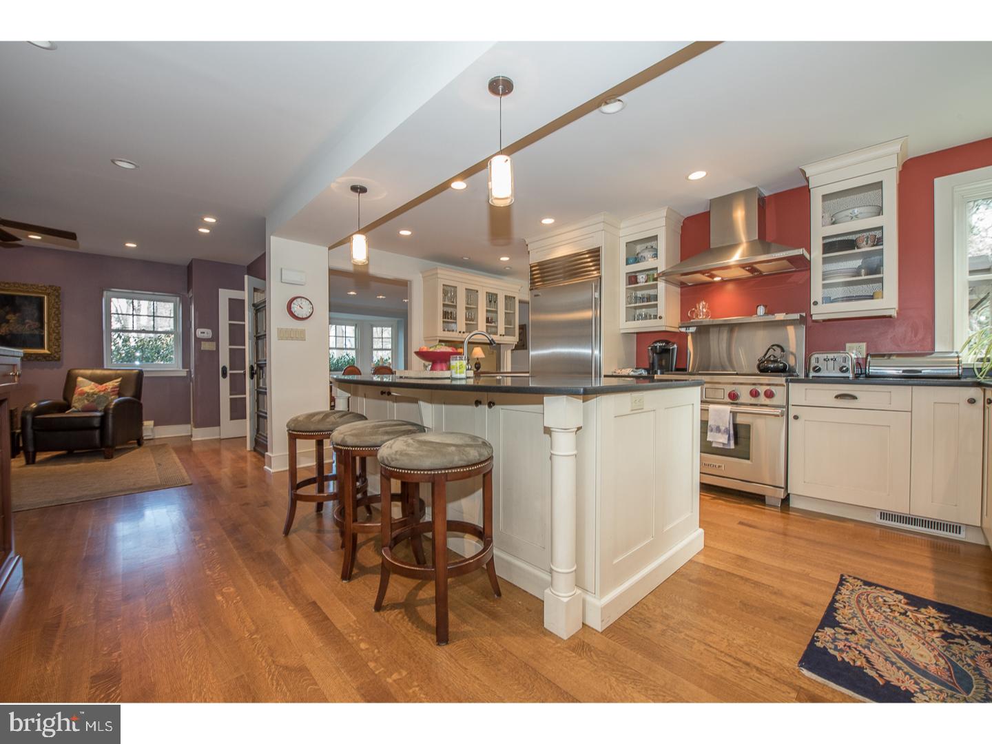 545 Manor Road Wynnewood, PA 19096 - Photo 10 of 25 a kitchen with stainless steel appliances granite countertop wooden cabinets a sink a stove a dining table and chairs
