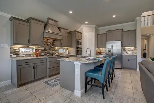 a kitchen with refrigerator and cabinets