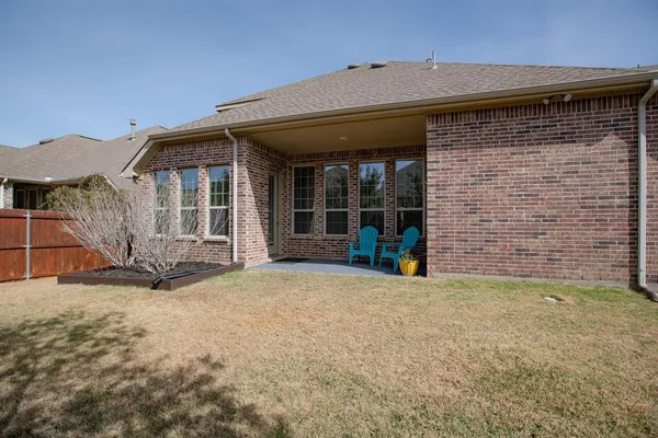 a backyard of a house with lots of trees