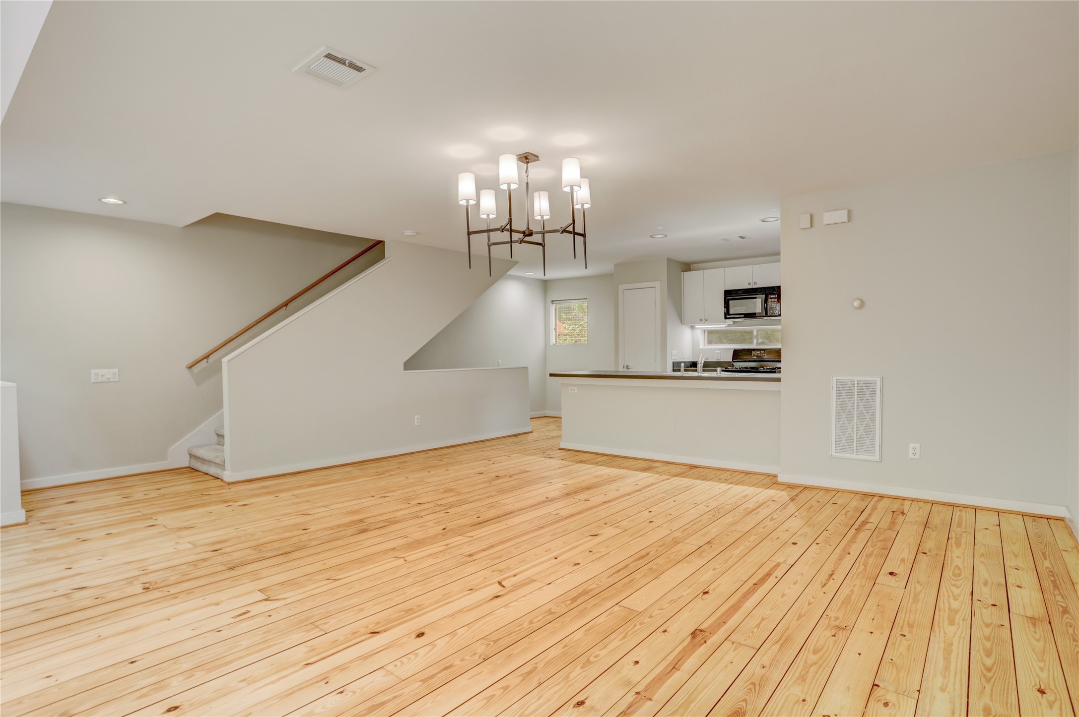 910 Ruthven Street Houston, TX 77019 - Photo 5 of 35 Contemporary vibe makes it feel like a loft. Carpeted stairs to the third floor from the Living dining kitchen.