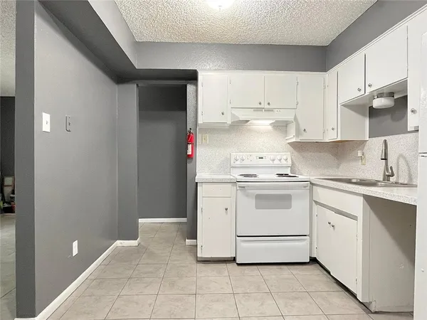 a white refrigerator freezer sitting inside of a kitchen