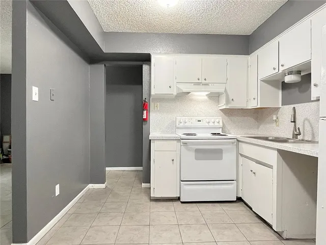 a white refrigerator freezer sitting inside of a kitchen