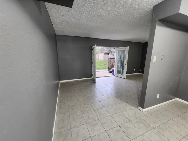 a view of a livingroom with an empty space and a window